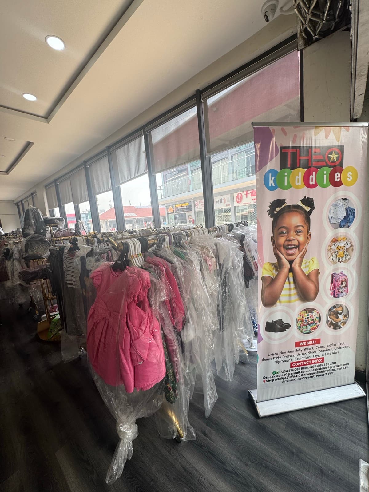 Physical Theo Kiddies store with colorful children's outfits on display