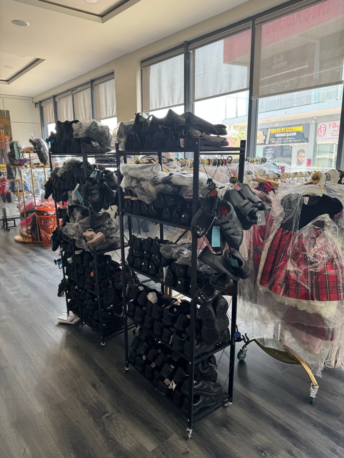 Physical store shelves and rails filled with children's fashion items